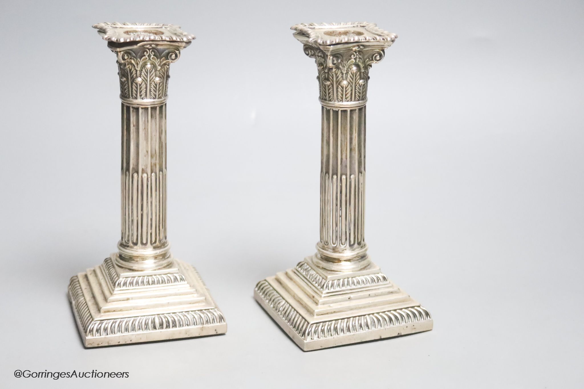 A pair of late Victorian silver Corinthian column dwarf candlesticks, Atkin Brothers, Sheffield, 1899, 17.6cm, weighted.